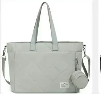 Grey quilted baby changing bag with shoulder strap and pouch